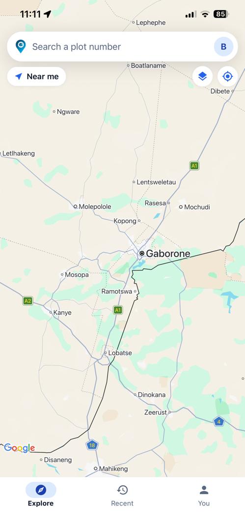 The PlotFinder map open over southern Botswana, with an empty plot number search box across the top and a "Near me" button beneath it.